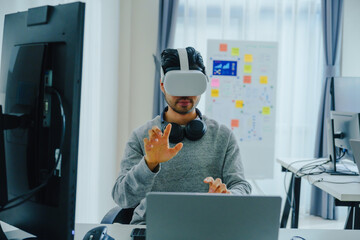 Asian and Indian developer program coding sent to virtual reality headset to implement ai project at office