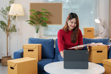 Startup businesses or small SME business owners, conducting online business and checking stock before sending products according to customer orders. Order products online at home office.