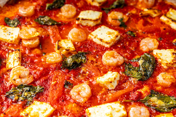 Pizza with seafood and basil close-up. Background.