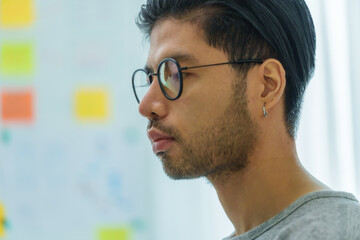 Asian man  prompt engineer develop coding app with software data sitting in front of computer...