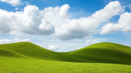 Fototapeta premium Expansive rolling green hills beneath a partly cloudy sky, perfect for adding your custom text above.