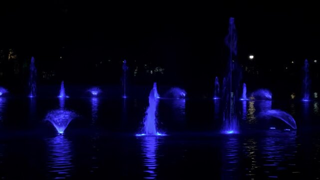 Close up of multicolor musical fountain in Plovdiv. Singing fountain in the Tsar Simeon's Garden. Water attraction. Water light show.