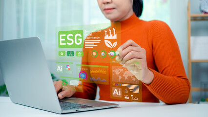 Woman hand using stylus pen to analyze ESG on screen in business investment strategy concept, ESG...