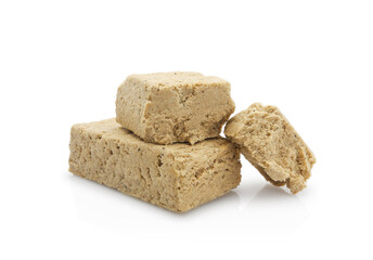 Pieces of halva from sunflower seeds, isolated on white background  