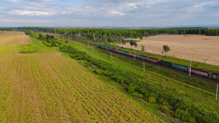 drone flying over the field along the railway