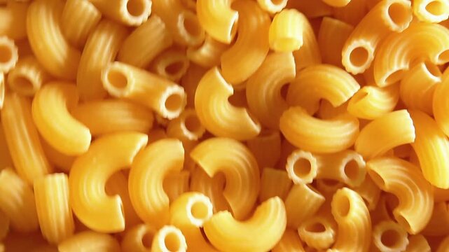 Uncooked Chifferi Rigati Pasta - Top View, Low Key Light. Fat and Unhealthy Food. Classic Dry Macaroni, Rotating Background. Italian Culture and Cuisine. Raw Golden Pasta Texture - Side Rotation Left