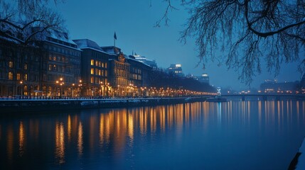 Obraz premium Winter scene in hamburg, germany - illuminated city architecture reflecting in the tranquil waters of binnenalster lake at dusk, showcasing historic buildings and lights against a crisp winter sky