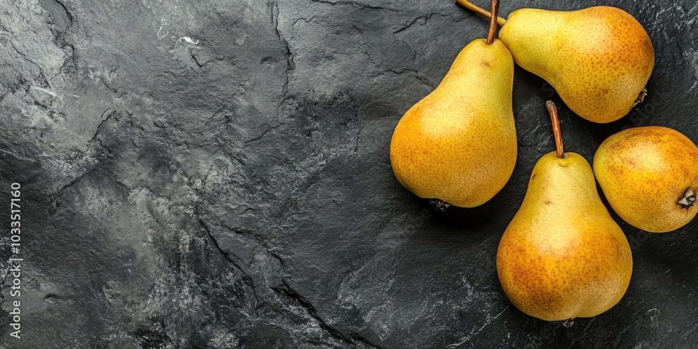 Poster fresh pears on a black stone surface. fruits. free space for text. top view.