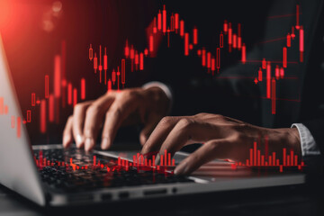 Stressed businessman analyzing financial data on a laptop with red stock market graphs overlay, depicting a market crisis.