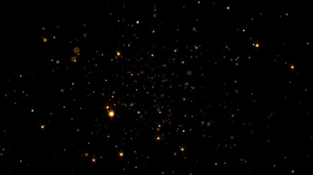 Abstract background with glittering gold dust particles on a black background.