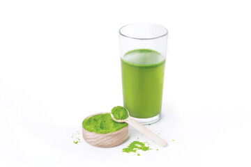 Glass with fresh wheatgrass juice on white background photo