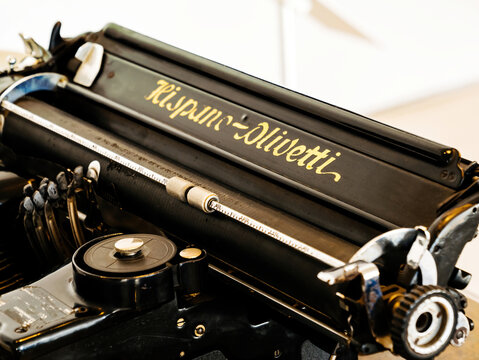 Palma, Spain - Jul 5, 2024: An elegant vintage Olivetti typewriter on a wooden desk, evoking a sense of nostalgia from the era of manual typing in offices and writing spaces