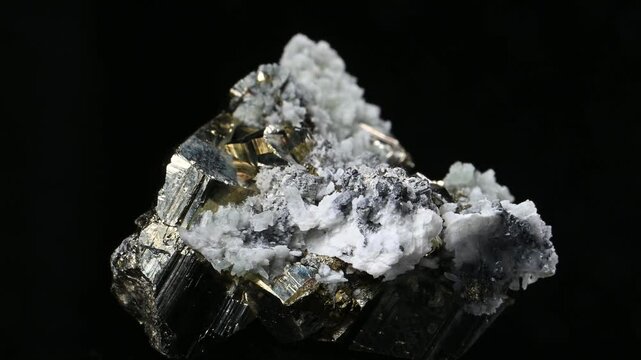 Iron Pyrite, quartz and chalcopyrite crystals  rotating slowly against a black background [Bulgaria]