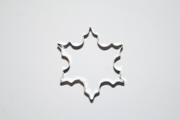 snowflake cookie cutter on white background