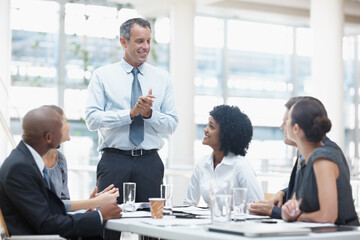 Businessman, presentation and discussion with team in meeting for corporate mission or ideas at office. Man, executive or speaker talking to group of employees for business growth or development