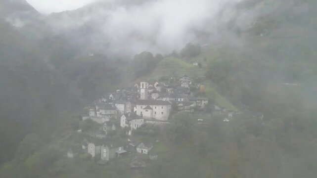 Foggy aerial view of the town of Corippo, Valle Verzasca, Switzerland.