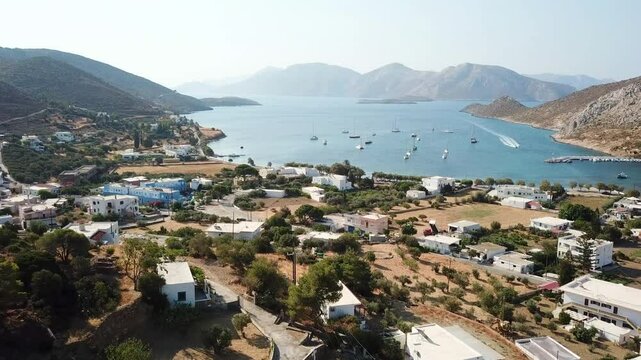 Greece, Leros Island,Xirocampos bay,aerial footage starts from the hill,flies over the town and moves towards to the bay.Camera turns around with a perfect angle and focuses on the bay, sailboats, sea