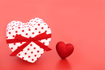 Heart shape Valentines Day gift box on red background. Love romance passion concept for a Valentine card, anniversary or birthday.