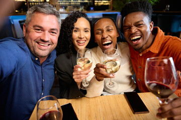 Caucasian and Black Colleagues hanging out together after work