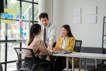 Strategic Collaboration: A focused team meeting in a modern office setting. The image captures the essence of brainstorming, idea generation, and collaboration. The bright.