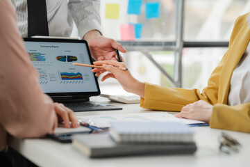 Business Data Analysis: A focused image of a collaborative team analyzing data on a digital tablet. The image captures the essence of strategy, insights, and collaboration.