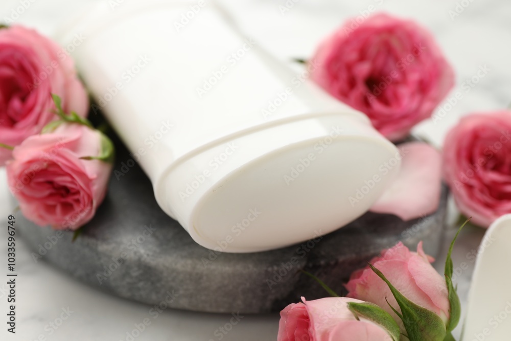 Wall mural Solid deodorant and beautiful rose flowers on table, closeup