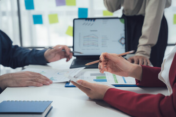 Business Meeting: A diverse team of professionals collaborate on a project in a modern office...