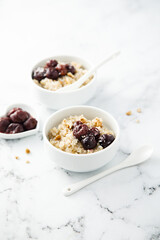Homemade pudding with warm cherries and coconut