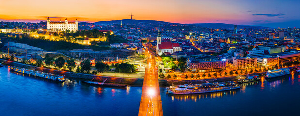 Bratislava, Slovakia - June 2022: City skyline on the shores of the Danube river; Bratislava castle, the old town, Eurovea; UFO bridge; SNP bridge; Appolo Bridge