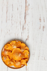 Frozen chanterelles in a plate on the table. Forest mushrooms. Selective focus