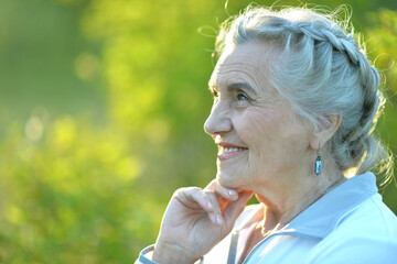 Portrait of a beautiful woman in the park in summer