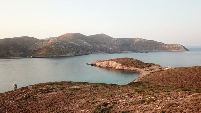 Greece,Leros Island,Archangelos bay,drone footage during sun rise,footage starts from fish farms and moves slowly towards small islands and sun. Camera stops at the boats anchored at the bay.