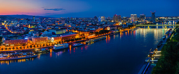 Bratislava, Slovakia - June 2022: City skyline on the shores of the Danube river; Bratislava castle, the old town, Eurovea; UFO bridge; SNP bridge; Appolo Bridge