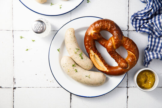 White sausages with salted pretzel
