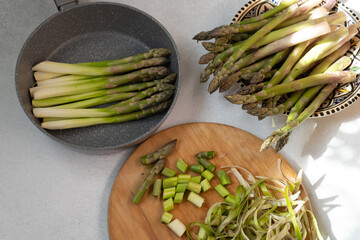 Cook asparagus. Peel and fry green asparagus sprouts. Vegetable healthy food.