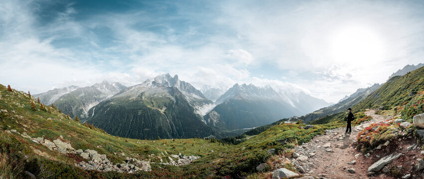 Panoramic view of a hiker in Swiss and French Alps