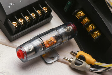 Car audio stereo system fuse box close up on the white workbench background.