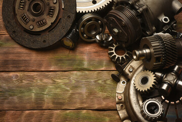 Car spare parts on the wooden workbench background. Top view.