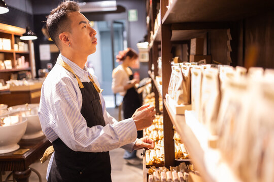 Chocolate store worker browsing products
