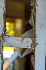 Wooden window frame with remains of broken glass
