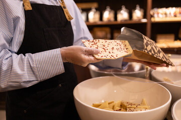 Artisan chocolate shop selecting gourmet delights