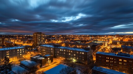 Fototapeta premium A nighttime cityscape illuminated by streetlights under a dramatic sky.