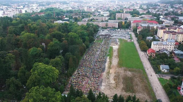The graves of dead Ukrainian soldiers who died during the Russian invasion of Ukraine. Drone footage of military graves against the background of the city. Lviv Field of Mars, on which there are a