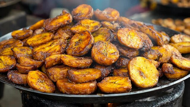 Fried plantains are being cooked over an open fire in a street food market