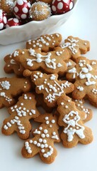 A close-up of gingerbread cookies decorated with white icing in the shape of Christmas trees.