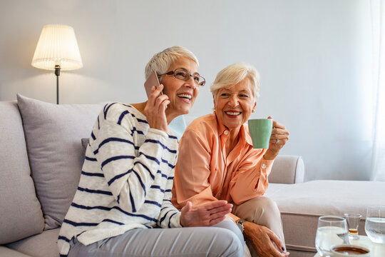 Two Senior Women Enjoying Coffee and Conversation at Home