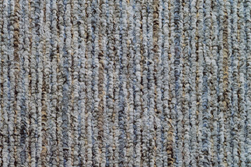 Surface of gray carpet floor. Vertical seam. Top view.