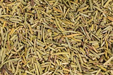 Background macro dried rosemary leaves top view, seasoning texture.