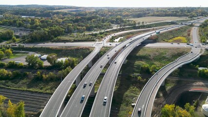 Many vehicles drive along the Golden Gate Bridge road. Bridge roadbed goes from above the water and to the land. Aerial topdown footage. Famous tourist attraction of San Francisco, California. 4k