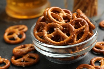 Delicious pretzel crackers on black table, closeup